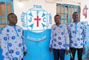 Current and former leaders of the Kabondo Center United Methodist Church youth committee stand in front of the church shop they operate to generate income for youth in Kabondo, Congo. Pictured (from left) are William Ilunga Mushimukata, Ngulu Mingi and Hugo Banza Kyakulomba. Photo by the Rev. Betty Kazadi Musau, UM News.