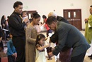 Young adult, Sekope Fainu (left), waits to receive Communion during worship at Tongan United Methodist Church in West Valley City, Utah. Photo by Kathleen Barry, UM News.