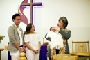 The Rev. Anne Lau Choy baptizes an infant at St. Paul United Methodist Church in Fremont, Calif. Photo by Brian Teodoro.