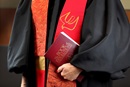 The 2012 edition of The Book of Resolutions of The United Methodist Church is held by an ordained clergy. Photo illustration by Kathleen Barry, United Methodist Communications.
