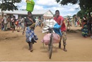 Woman and man carry relief supplies provided by the church of Malawi. The church of Malawi hopes to provide additional relief to cyclone survivors.