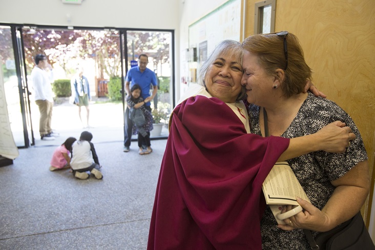 Lay Leader, Vi Bautista (choir robe) and Rhonda McDonald greet each other between services at St. Paul United Methodist Church in Fremont, Calif. Photo by Kathleen Barry, United Methodist Communications
