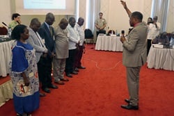 Central Congo Bishop Daniel O. Lunge prays for the newly elected leaders of the African Association of United Methodist Theological Institutions during a meeting in Kinshasa, Congo, in late October. Photo by Eveline Chikwanah, UM News. 