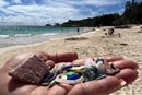 Photo shows a handful of plastic debris collected from the sand at Kailua Beach