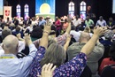 
Attendees of the Kentucky Annual Conference raise their arms in prayer in the morning "Worshipful Work, Plenary." The conference met June 12-14, and members participated in service projects during their annual meeting. Photo by Kathleen Barry, United Methodist Communications.