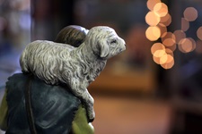 A nativity figure of a shepherd holds a young lamb. Photo by Kathleen Barry, United Methodist Communications.