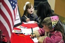 Children at First United Methodist Church of Lancaster, Pa., write thank you notes to give to wounded veterans and those serving in the military.