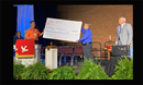 On Monday morning, June 6, Rev. Garth Duke-Barton, pictured above in blue, presented a check to the Kamina Orphanage and the Wings of the Morning Aviation ministry of the North Katanga Conference. Receiving the check on the behalf of Global Ministries were Jim and Bernice Keech, SEJ mission advocates. 
