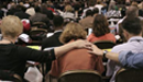 General Conference delegates pray over their decision making. 