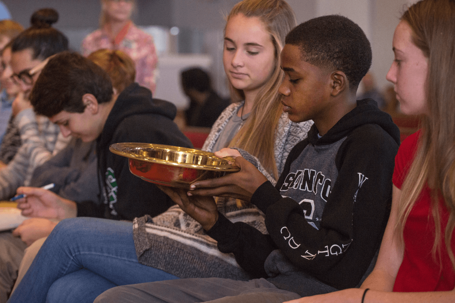 Youth pass the offering plate at McKendree UMC in Lawrenceville, Georgia