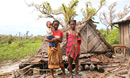 A mother of two stands by the remains of her home, which was destroyed by Cyclone Freddy in the Mananjary district of Madagascar. Photo by Justin Rakotoarimanana.
