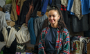 Natalia, a Ukrainian refugee, pauses as she sorts clothes at the CWS Balti Center in Moldova. She and her family have found “a warm hug” in this Moldovan community. Photo: Church World Service.