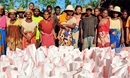 Survivors of Cyclone Freddy in Andranomavo, Madagascar, receive food aid from the UMC in Madagascar with a grant from UMCOR. (Photo: Justin Rakotoarimanana)