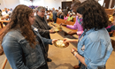Acacia Zuninga (left) and the Rev. Jorge Ramirez offer Holy Communion during a Festival of Nations celebration of World Communion Sunday at Hillcrest United Methodist Church in Nashville, Tenn. They help lead the Casa de TransformaciÃ³n congregation that worships at Hillcrest.